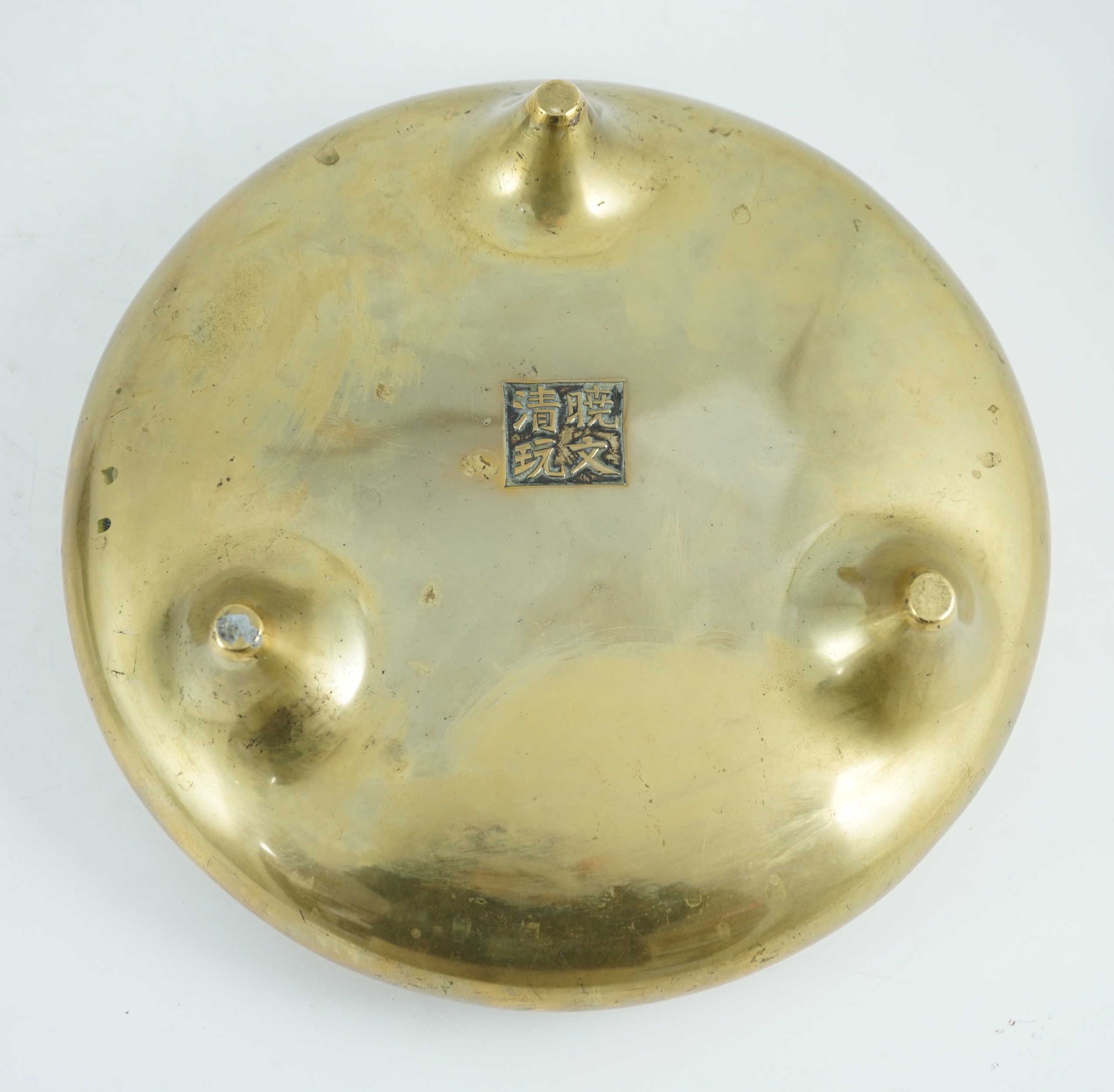 A large Chinese polished bronze tripod censer, 19th century, private four character seal mark, 29.5 cm diameter, Disc shaped rosewood stand